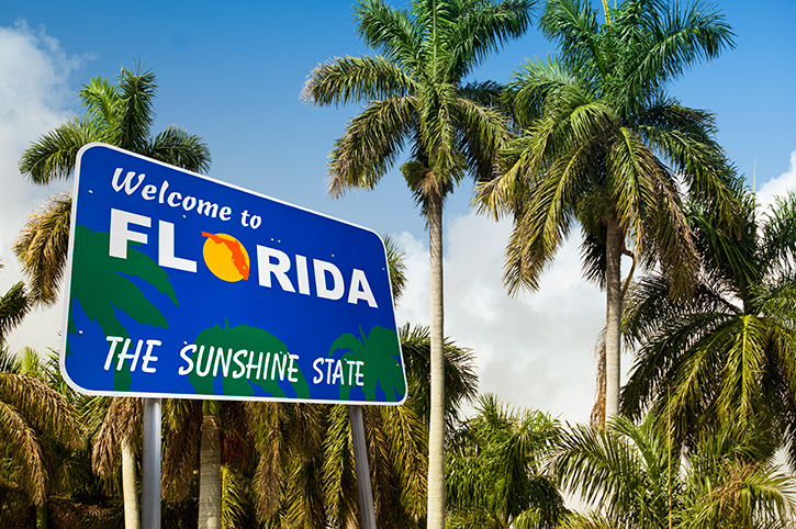 Welcome to Florida - The Sunshine State sign with palm trees